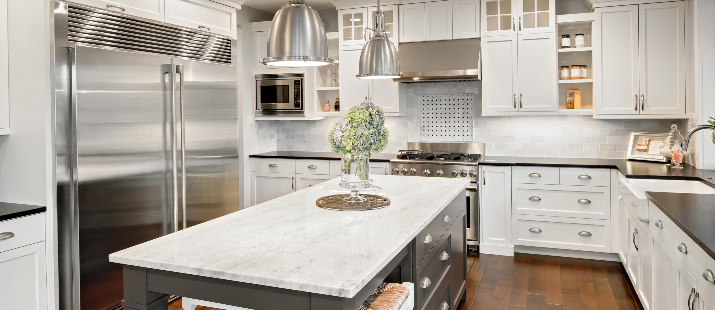 White and grey shaker cabinets with white and black countertops