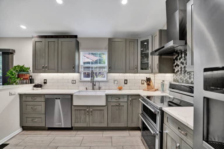 Farmhouse style kitchen project in Stafford VA with gray shaker cabinets, white countertops, and beige tiles flooring