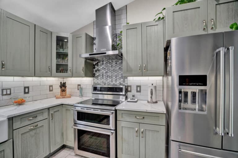 Farmhouse style kitchen project in Stafford VA with gray shaker cabinets, white countertops, and beige tiles flooring