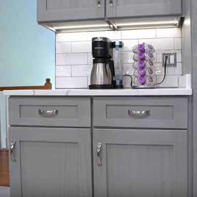 Grey shaker cabinets with white backsplash