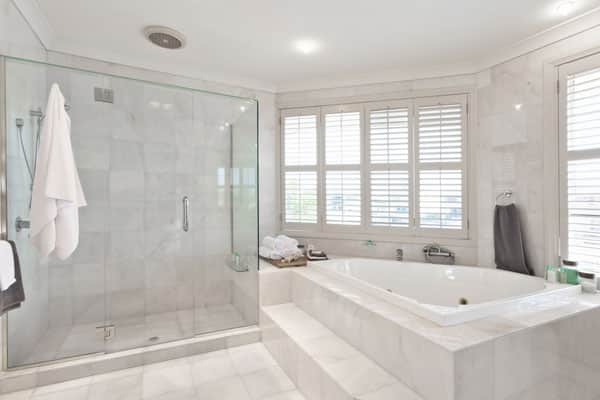 White bathroom with tub and shower