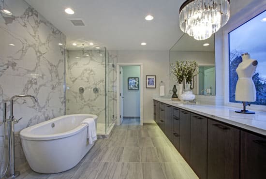 Elegant bathroom with brown vanity, tub, and shower