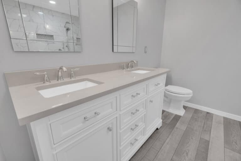 Spacious light gray bathroom project in Fredericksburg va with white vanity, and toilet