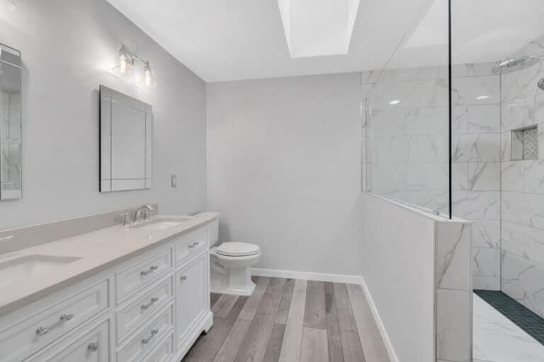 Spacious light gray bathroom project in Fredericksburg va with white vanity, and toilet