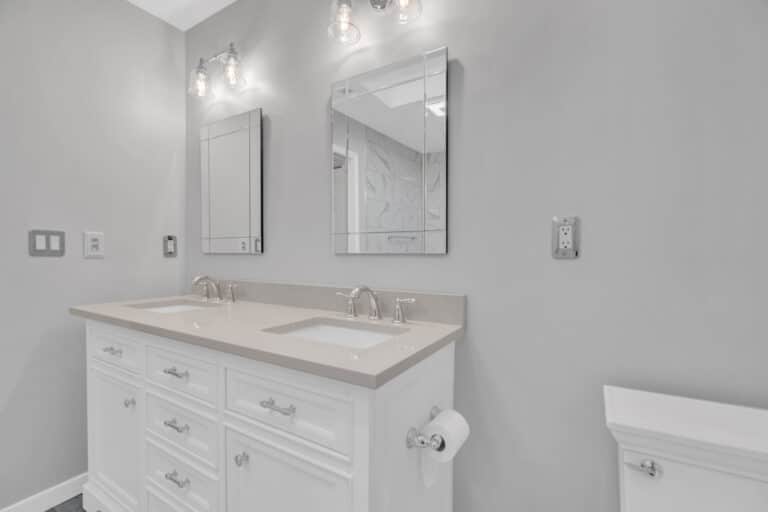 Spacious light gray bathroom project in Fredericksburg va with white vanity, and toilet