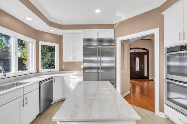 Brown kitchen project in locust grove va with white cabinets with glass door on wall cabinets, and white countertop