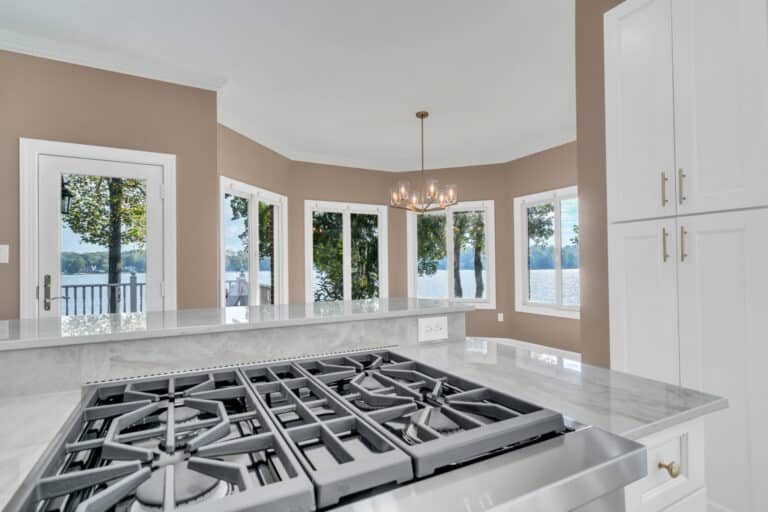 Light gray countertop on kitchen island, white cabinets