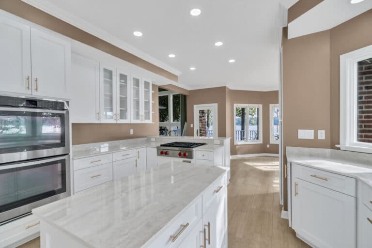 Brown kitchen project in locust grove va with white cabinets with glass door on wall cabinets, and white countertop