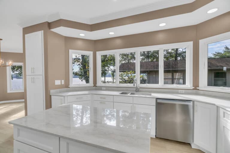 Light gray countertop on island with white shaker cabinets