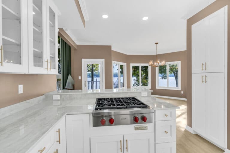 Brown kitchen project in locust grove va with white cabinets with glass door on wall cabinets, and white countertop