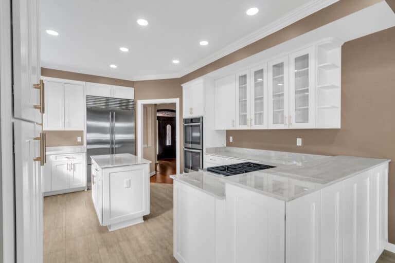 Brown kitchen project in locust grove va with white cabinets with glass door on wall cabinets, and white countertop