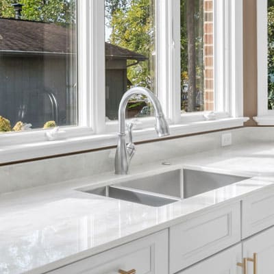 Chrome faucet and sink on light gray countertop