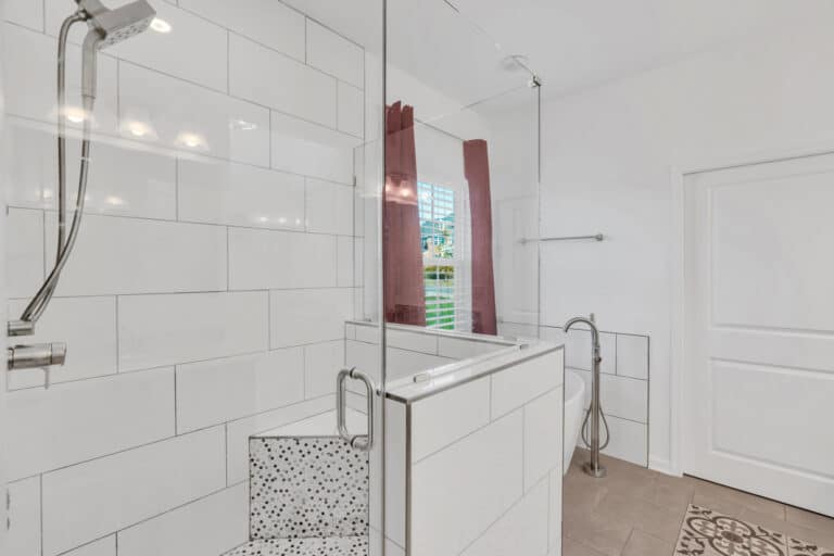 Shower with white tiles surround