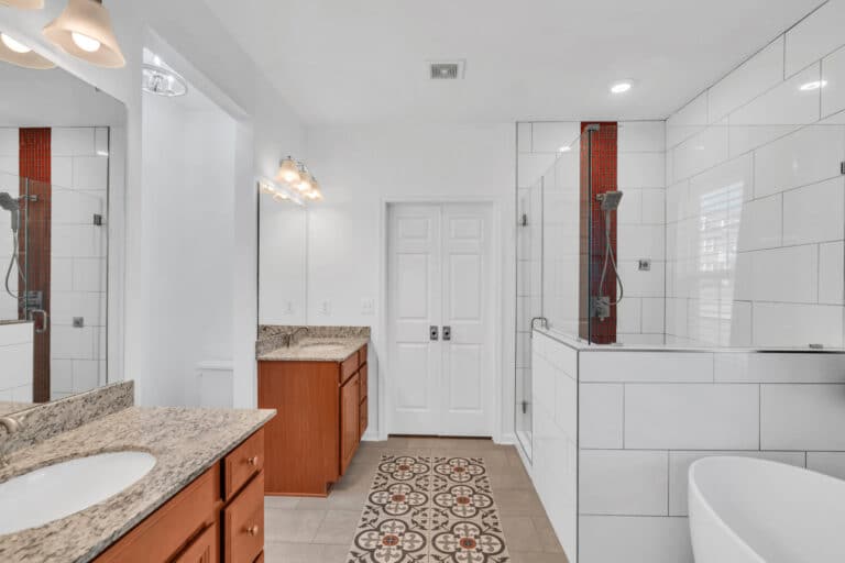 Spacious bathroom project in waldorf md with 2 brown vanities, tub, and shower