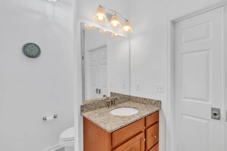 Brown vanity with granite countertop