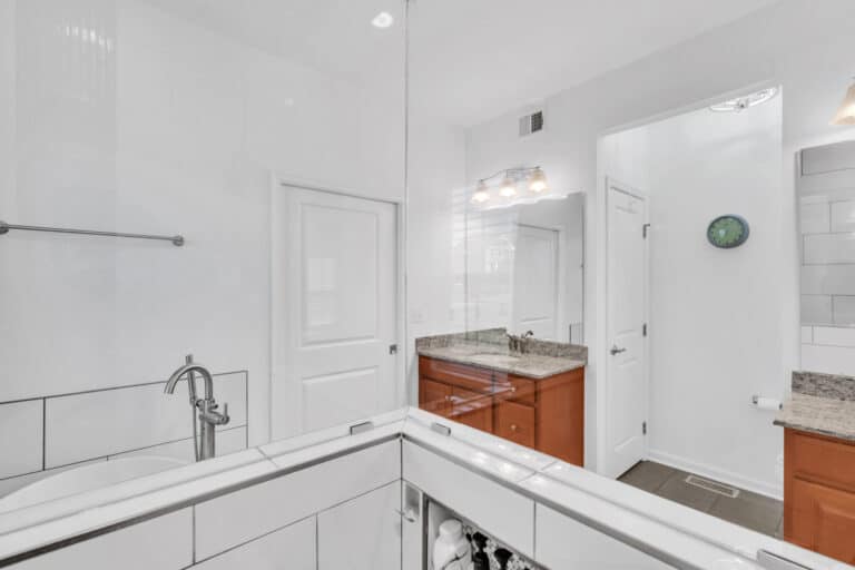 Spacious bathroom project in waldorf md with 2 brown vanities, tub, and shower