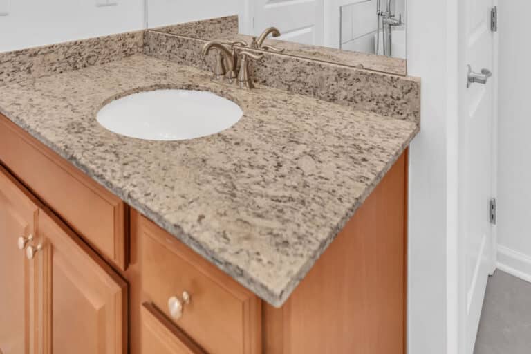 Brown vanity with granite countertop