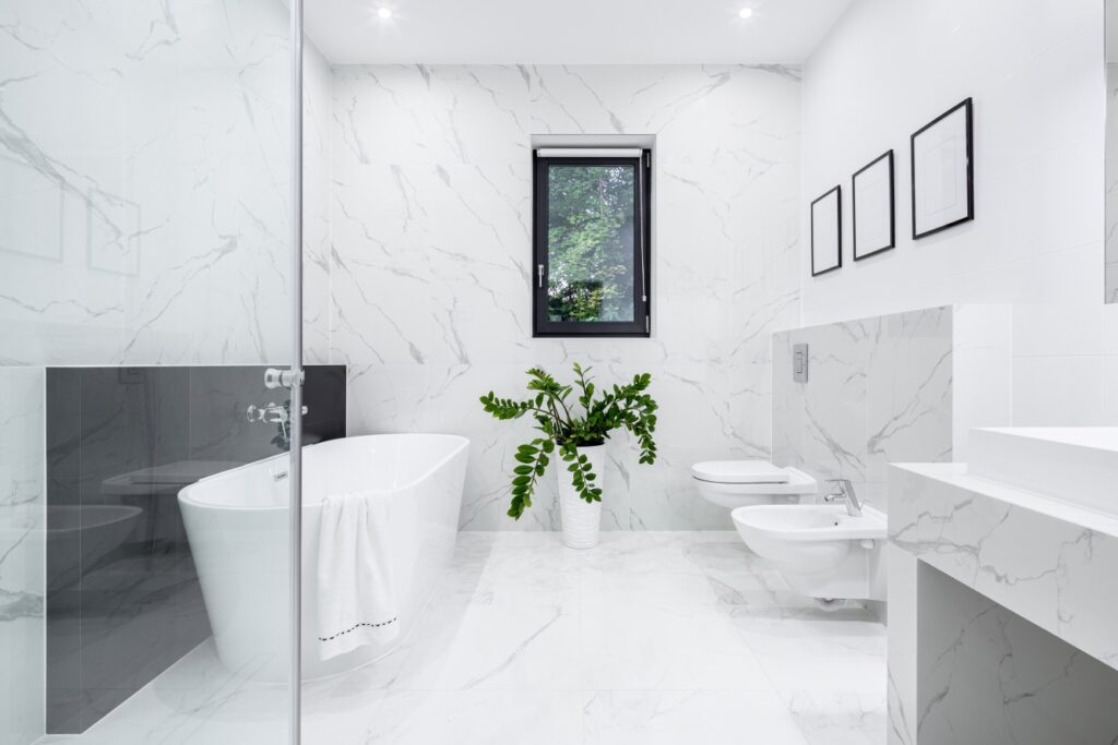 White bathroom with floating toilet, vanity, and tub