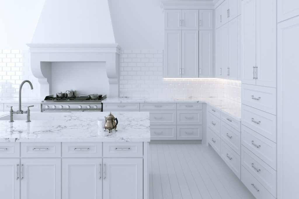 Full white kitchen with shaker cabinets and marble countertop