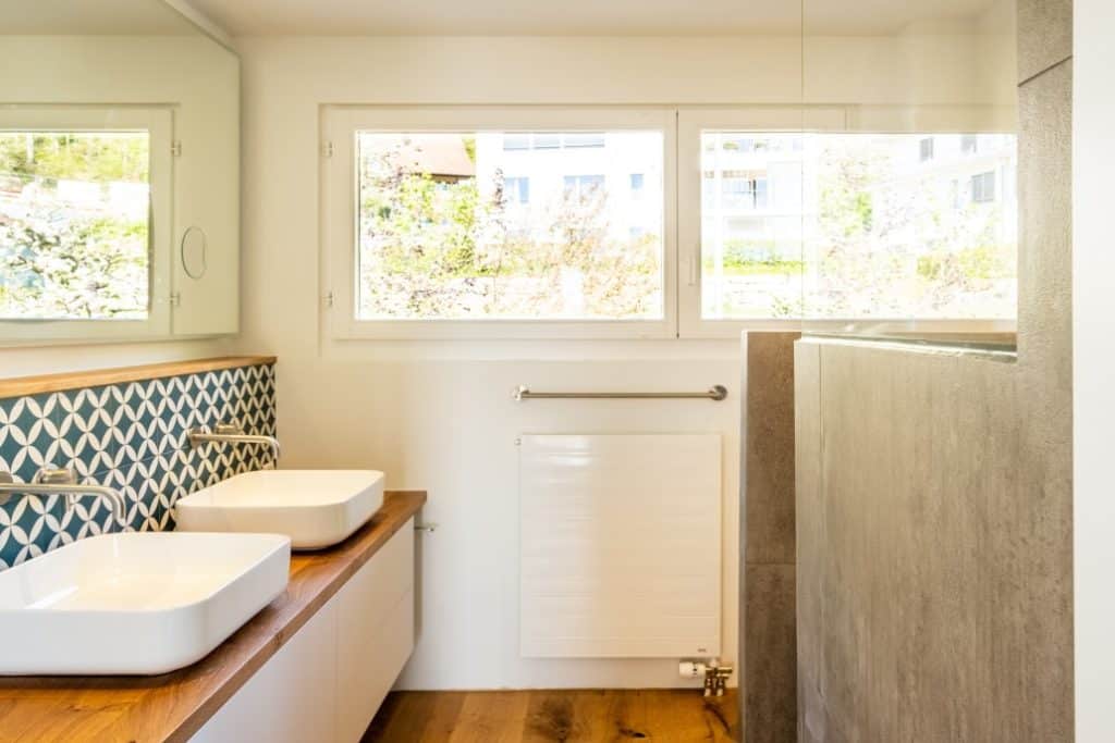 Bathroom with brown floating vanity with white cabinet doors and vessel sink