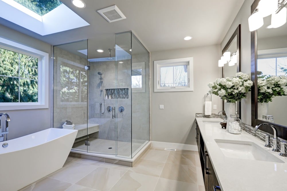 Elegant bathroom with brown vanity, tub and shower