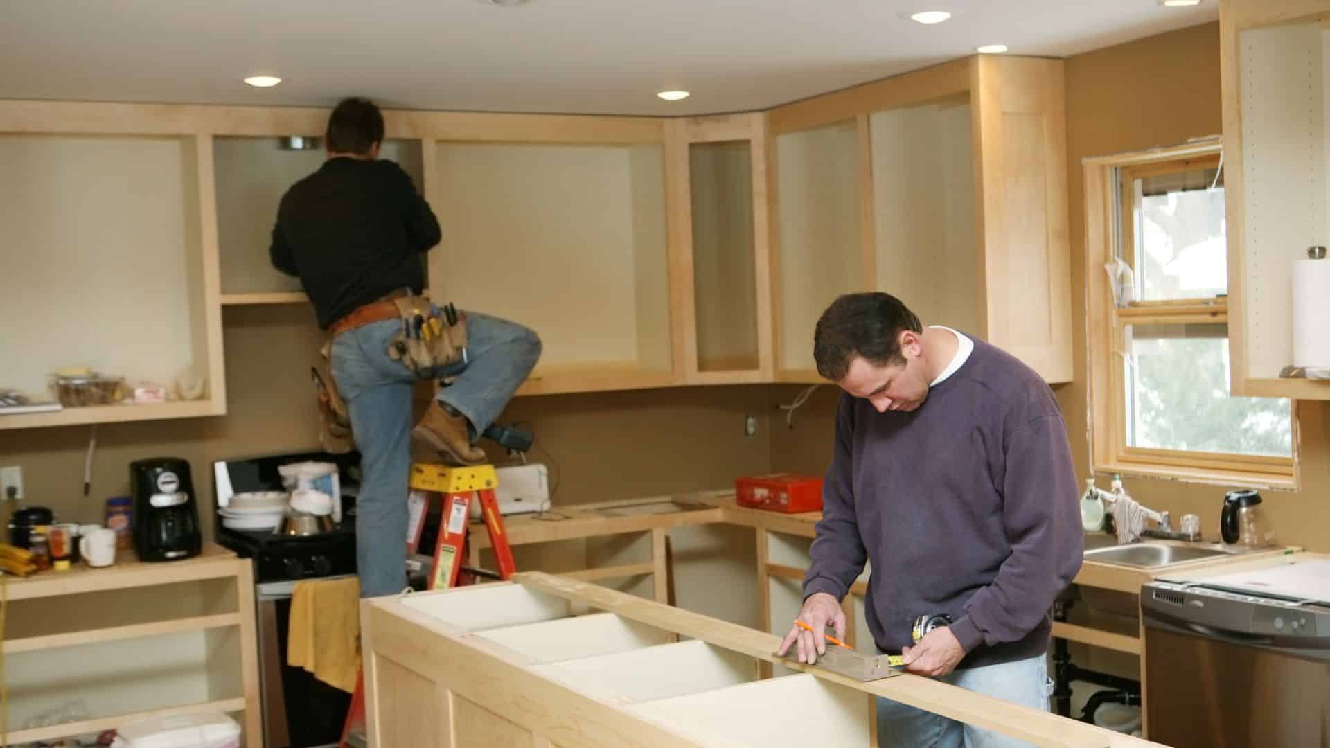 2 men doing labor in kitchen
