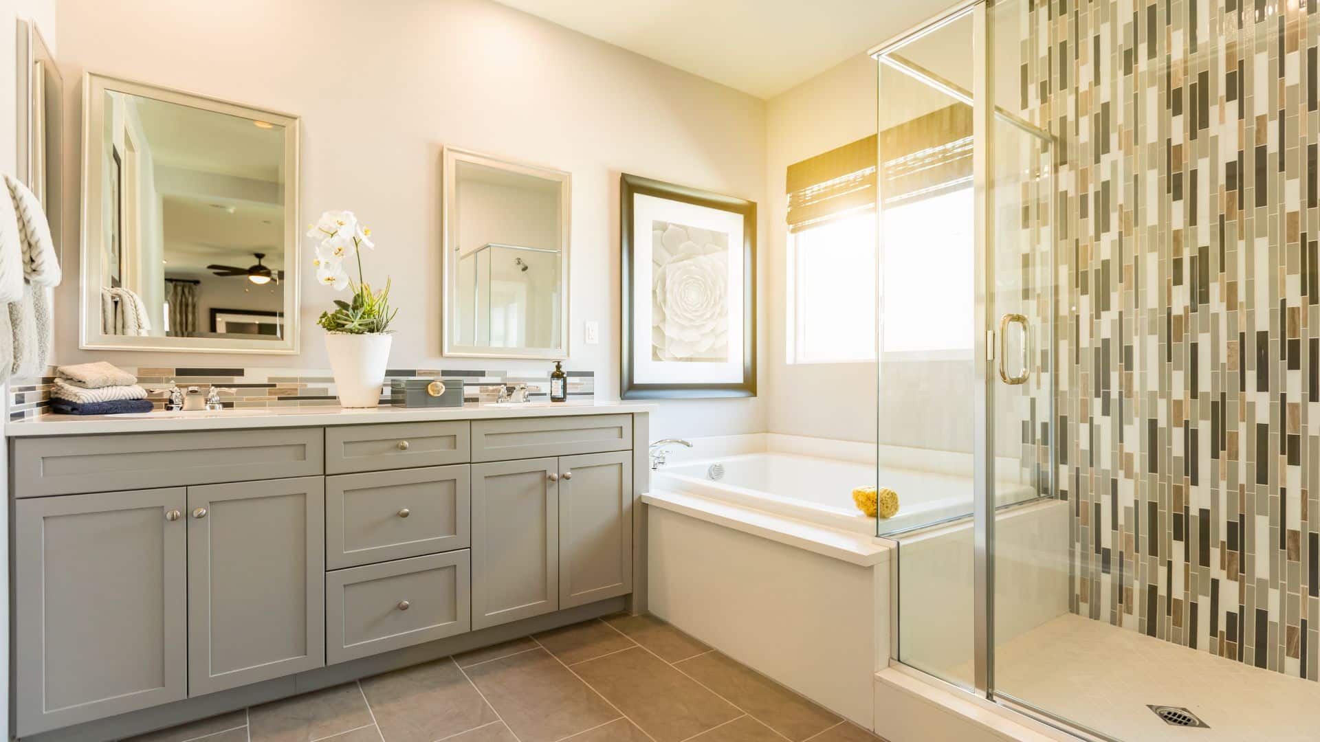 Spacious bathroom with gray shaker vanity, tub and shower