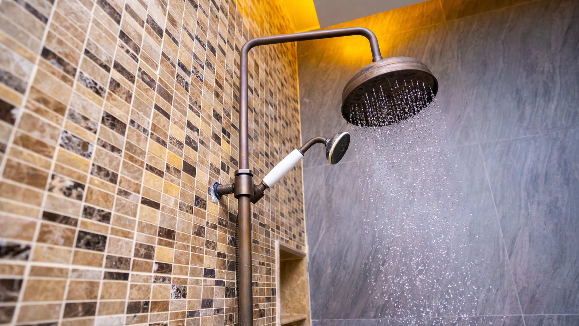 Zoomed in shower head with nice wall tiles
