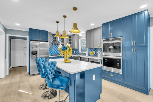 Blue shaker cabinets with wood flooring