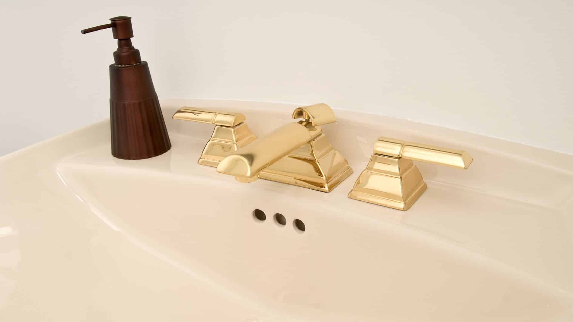 Gold faucet on sink