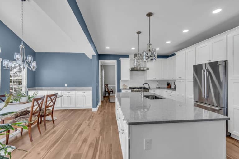 White kitchen cabinets and wood flooring