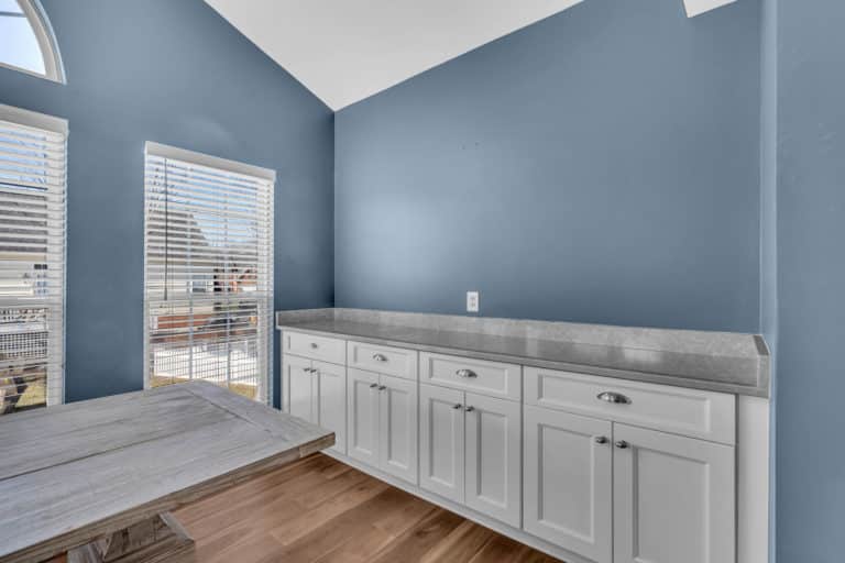 White kitchen cabinets and wood flooring