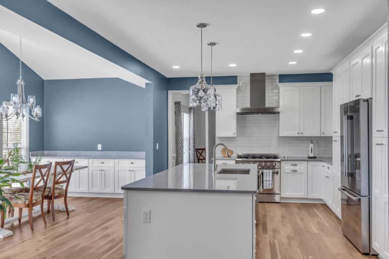 Elegant kitchen with white cabinets, gray countertop