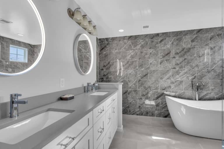 bathroom design with white cabinets, gray countertop, and tub Bathroom Remodeling Service in Clinton MD