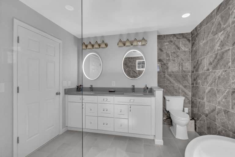 Luxurious bathroom with tub, white vanity, and shower