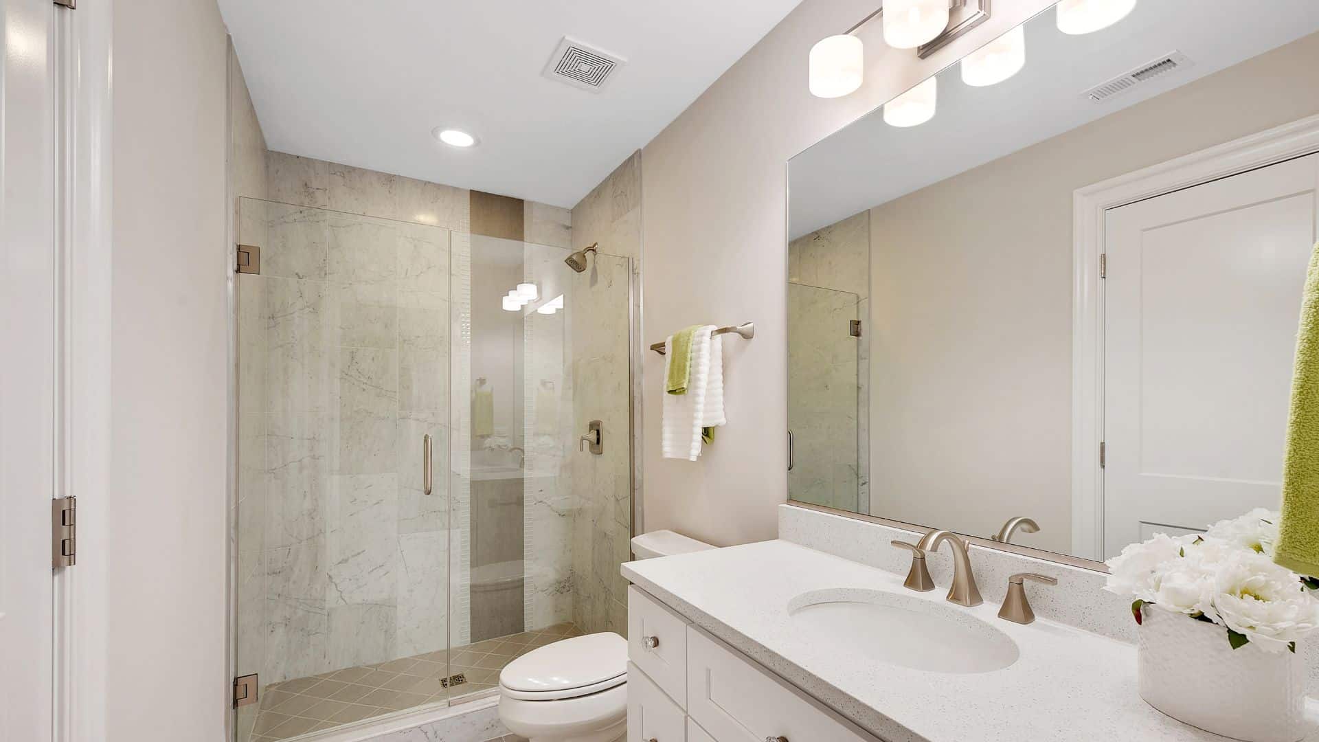 shower remodeling with white vanity, toilet