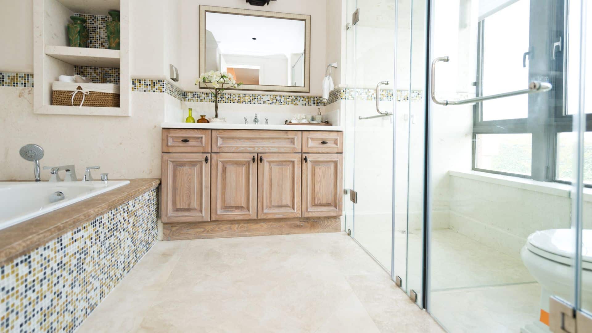 Elegant bathroom with light brown vanity, toilet, shower and tub