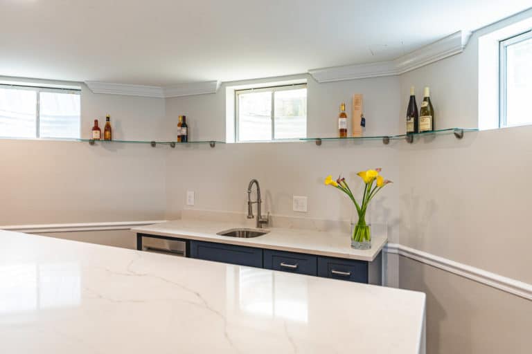 Basement bar with island and white countertop