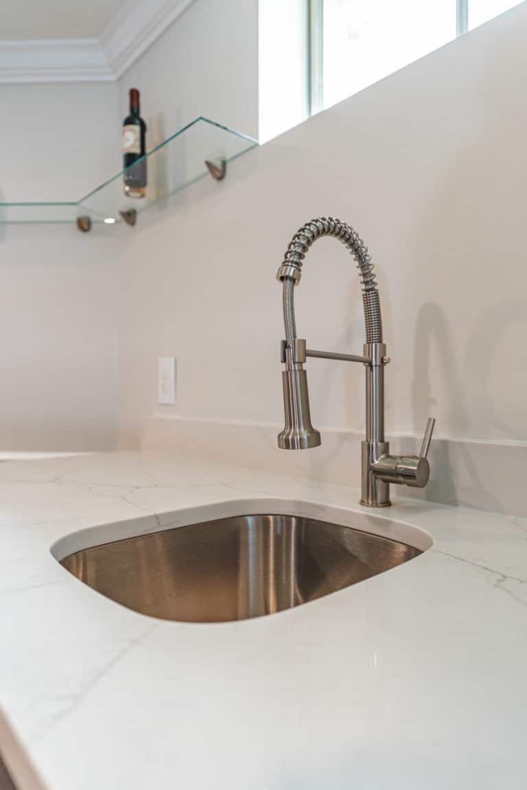 Faucet and sink on white countertop