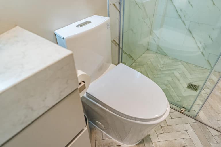 Small bathroom with floating vanity, toilet, and shower