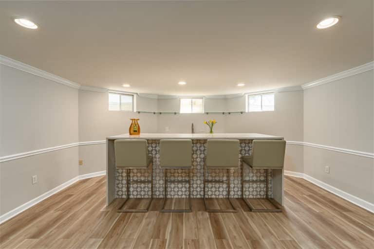 Basement bar with island and white countertop