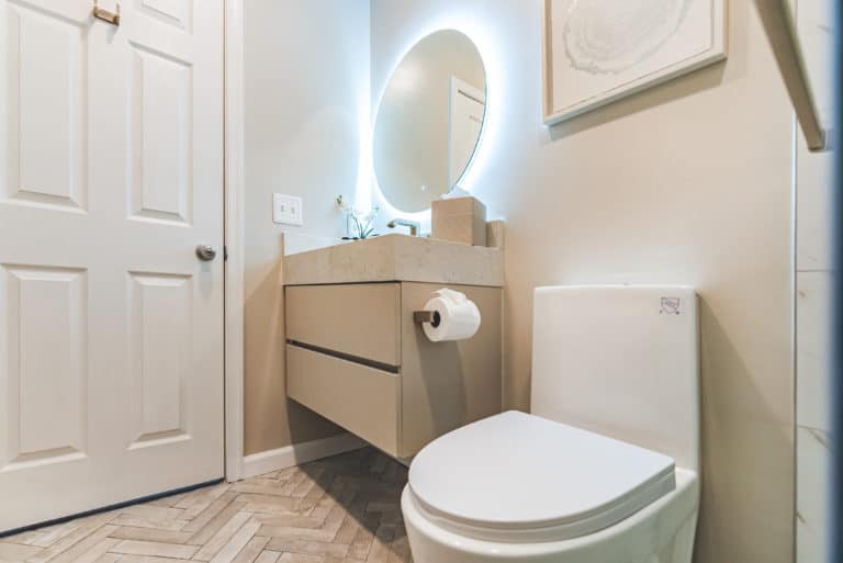 Small bathroom with floating vanity, toilet, and shower