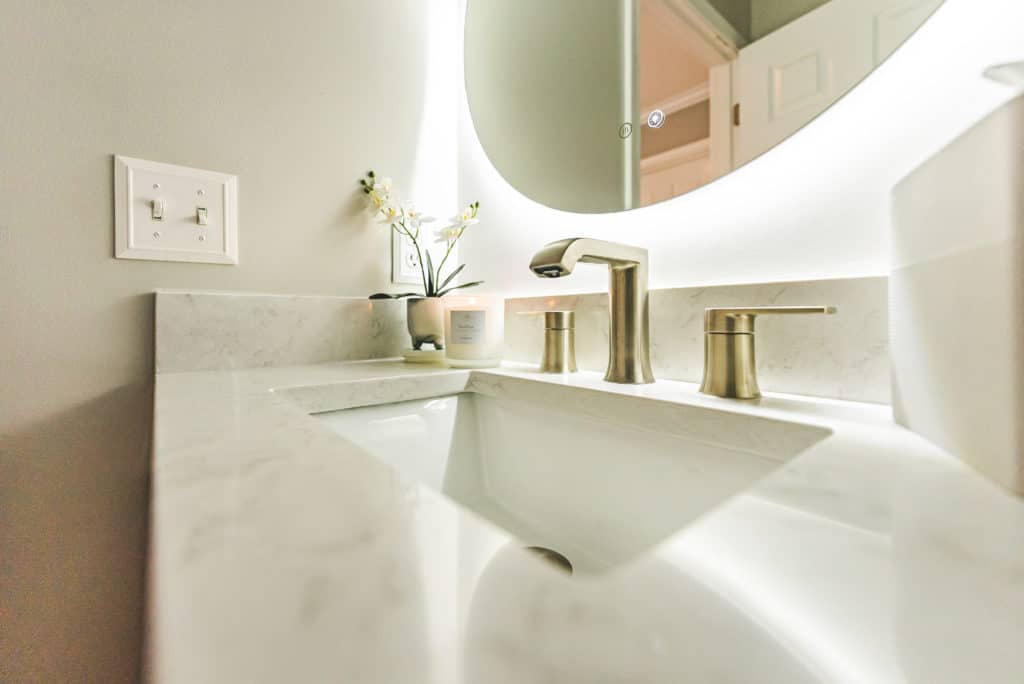 Bathroom countertop with gold faucet and sink