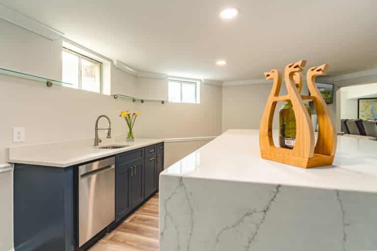 Basement bar with island and white countertop