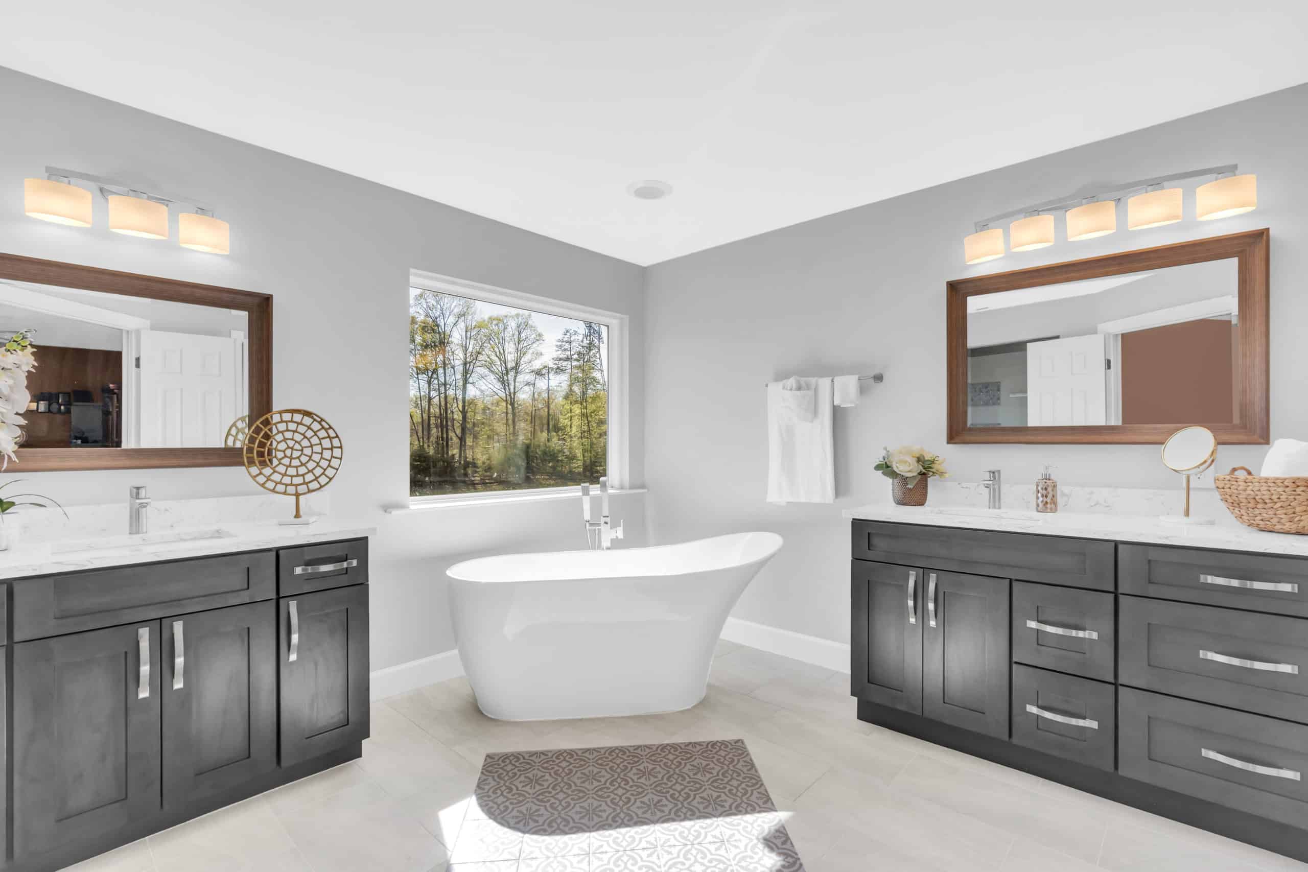 Elegant bathroom with 2 separated gray vanities and tub in middle