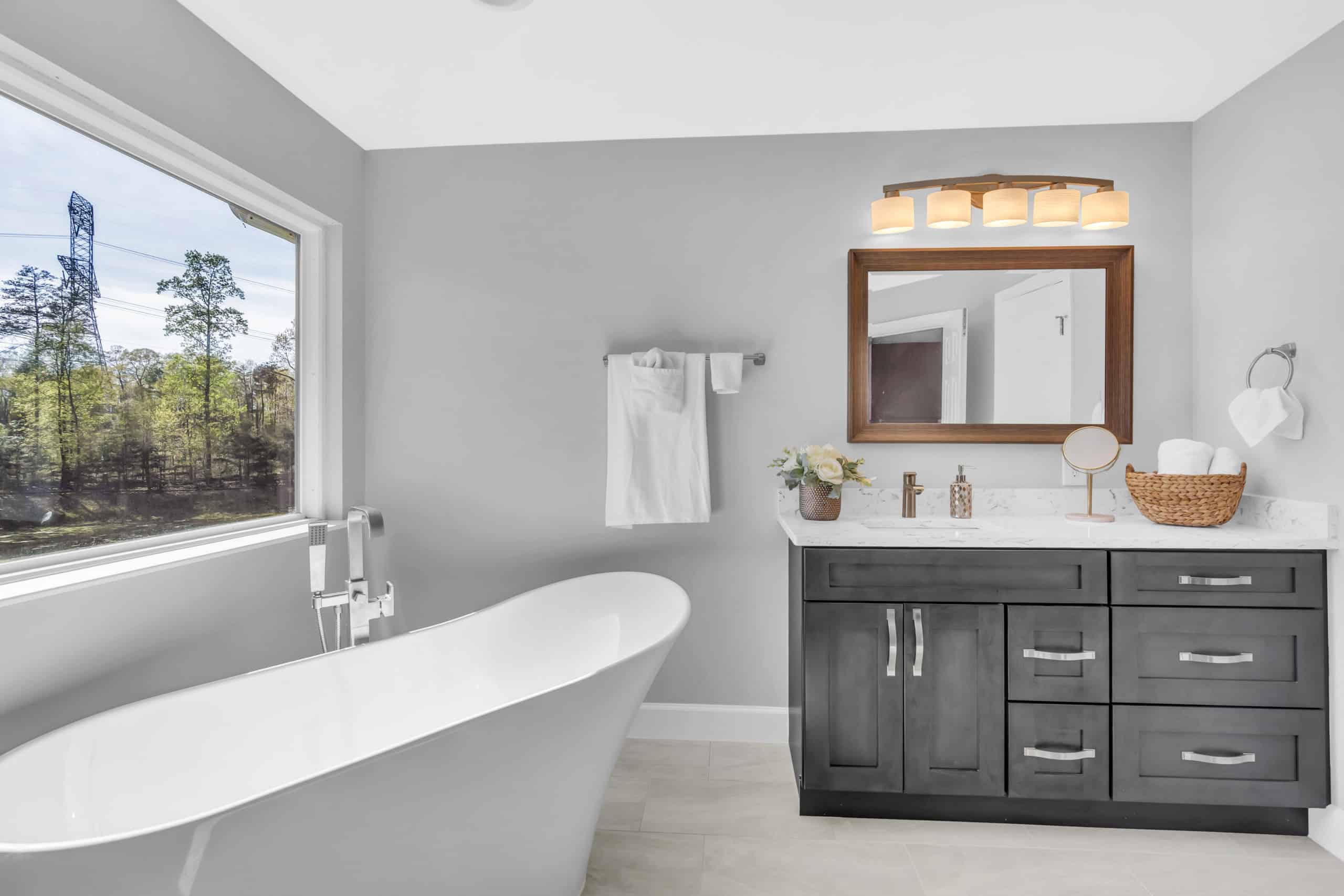 Elegant bathroom in maryland with gray vanity and tub