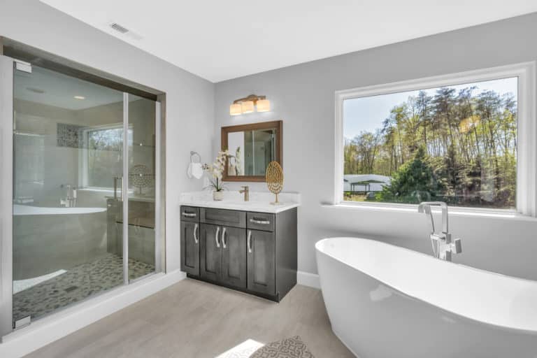 Elegant bathroom with gray vanity and tub