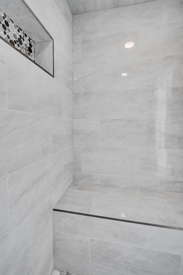 Shower with gray tiles surround