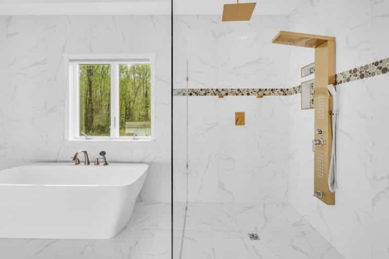 White bathroom with tub and shower