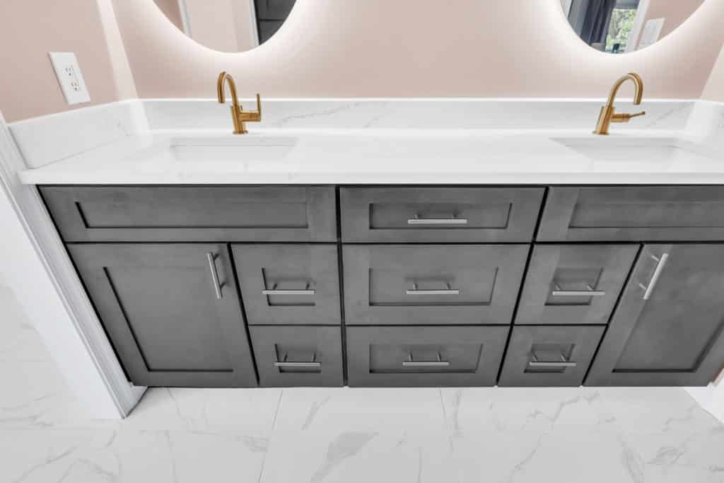 Double sink gray vanity with gold faucet